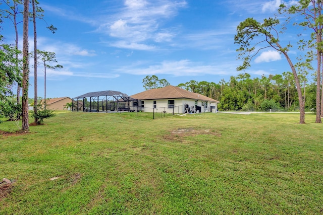 view of yard featuring glass enclosure