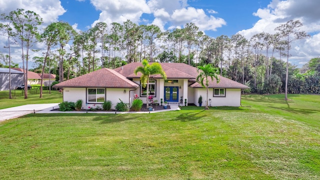 view of front of house featuring a front lawn and french doors