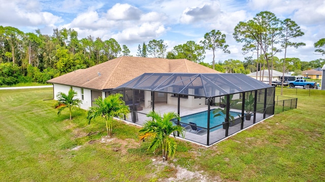 view of pool featuring glass enclosure, a patio area, and a yard