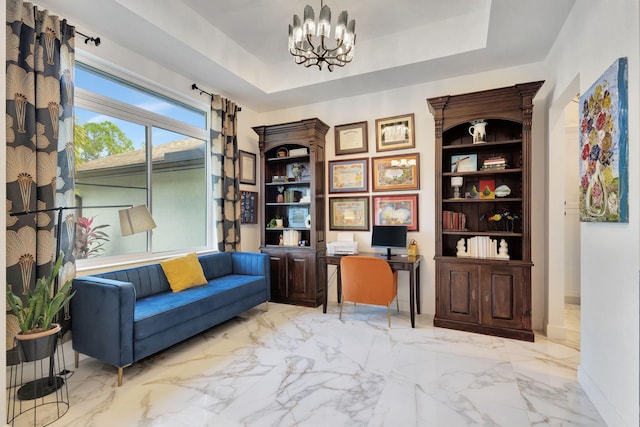 sitting room with a raised ceiling and a notable chandelier