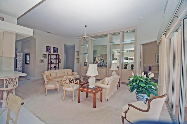 carpeted living room with ceiling fan