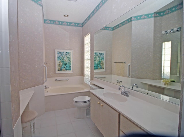 bathroom featuring toilet, a bathtub, vanity, and tile patterned flooring