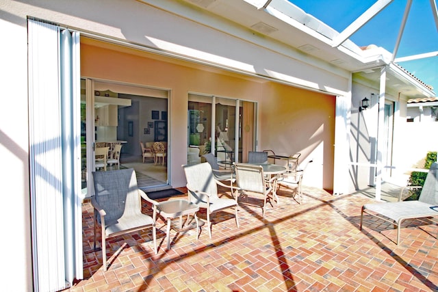 view of patio featuring a lanai