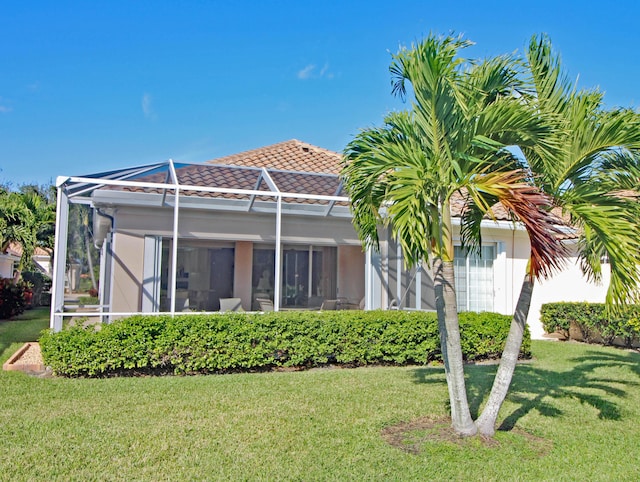 back of property featuring a yard and a lanai