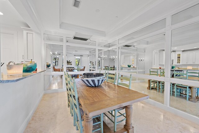 dining space with a chandelier and crown molding