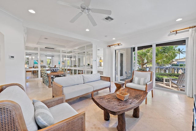 living room with plenty of natural light, ceiling fan, a raised ceiling, and crown molding