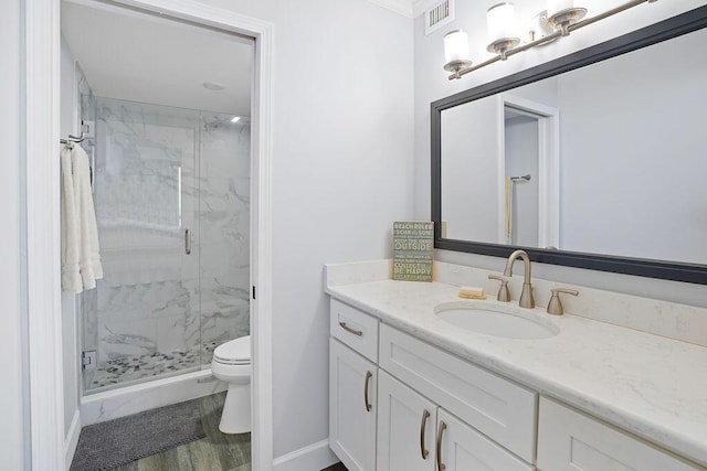 bathroom featuring hardwood / wood-style floors, vanity, toilet, and an enclosed shower