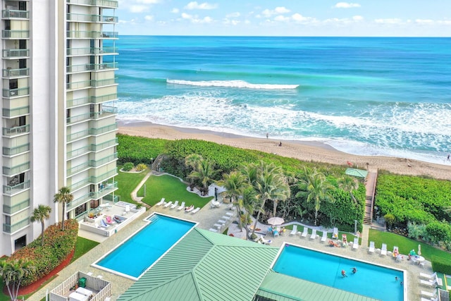 exterior space with a water view and a beach view