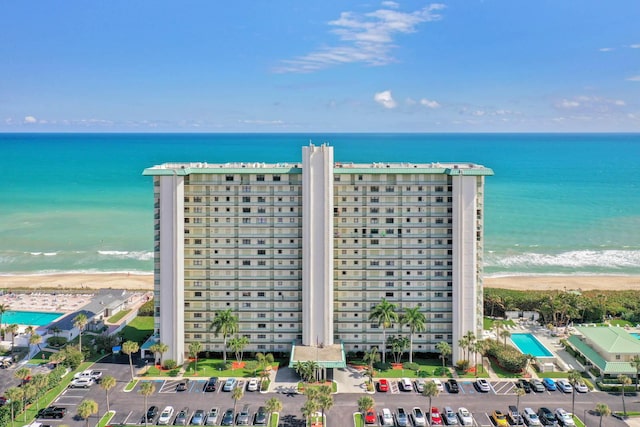 birds eye view of property with a view of the beach and a water view