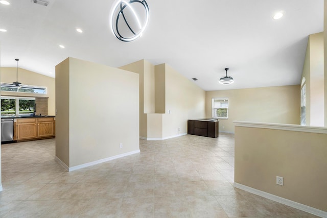 unfurnished living room with vaulted ceiling, light tile patterned flooring, and ceiling fan