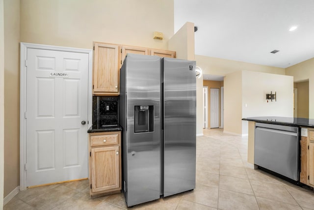 kitchen featuring light brown cabinetry, light tile patterned floors, and appliances with stainless steel finishes