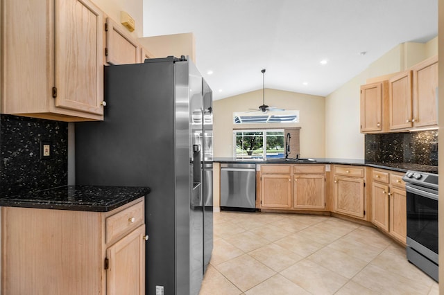 kitchen with tasteful backsplash, lofted ceiling, sink, light tile patterned floors, and stainless steel appliances