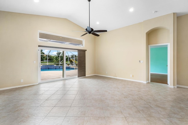 tiled empty room featuring ceiling fan and lofted ceiling