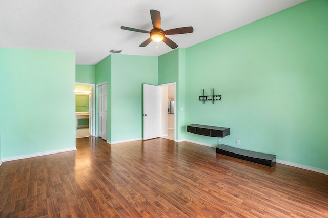 unfurnished bedroom featuring dark hardwood / wood-style flooring, ceiling fan, and ensuite bath