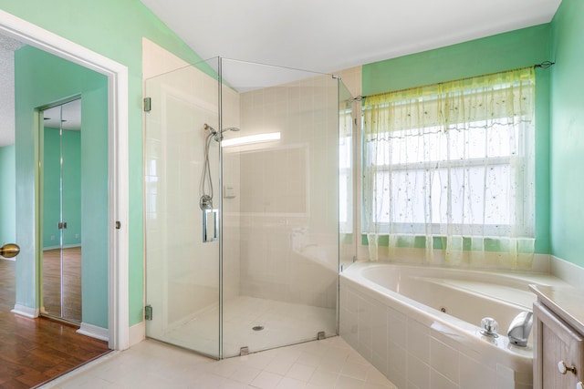 bathroom with tile patterned flooring and independent shower and bath