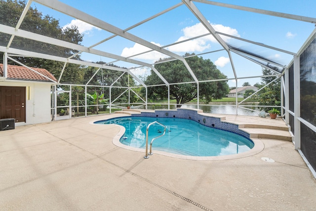 view of swimming pool with a lanai, a patio, and a water view