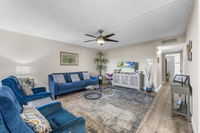 living room featuring a textured ceiling, hardwood / wood-style flooring, and ceiling fan