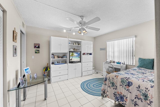 bedroom with a ceiling fan, visible vents, a textured ceiling, and light tile patterned floors