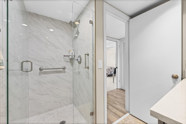 bathroom featuring vanity, wood-type flooring, and walk in shower