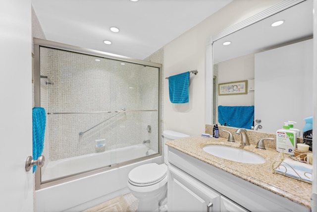 full bath featuring recessed lighting, vanity, toilet, and bath / shower combo with glass door