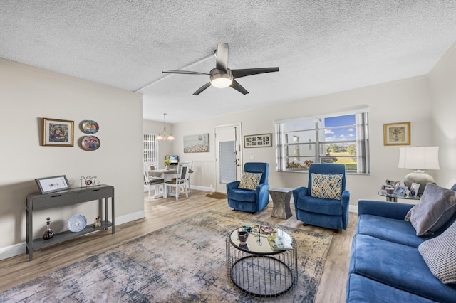 living room featuring wood finished floors, a wealth of natural light, and a ceiling fan