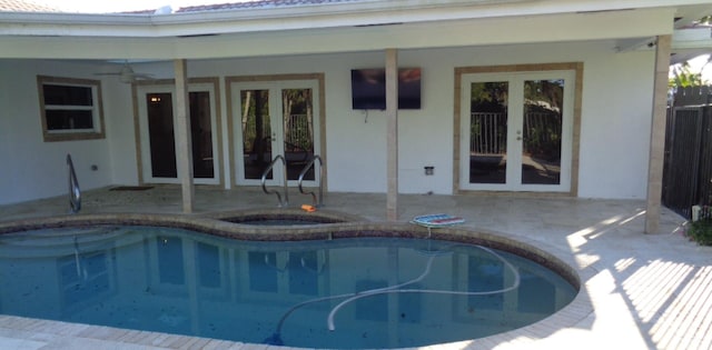 view of pool with a hot tub, ceiling fan, a patio area, and french doors