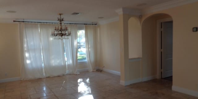 spare room with crown molding