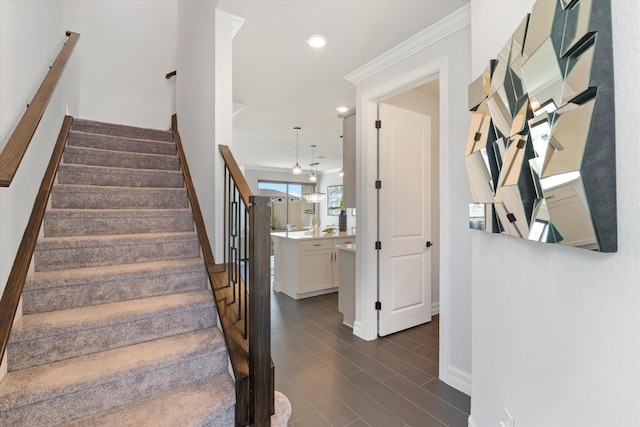 stairway featuring ornamental molding