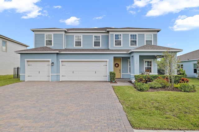 view of front facade with a garage and a front lawn