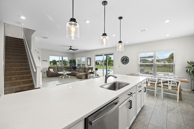 kitchen with ceiling fan, dishwasher, sink, pendant lighting, and white cabinets