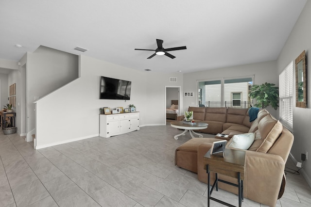 tiled living room with ceiling fan