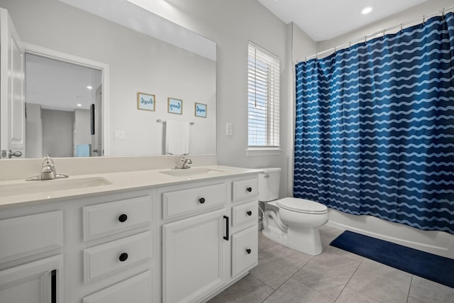 bathroom featuring tile patterned floors, vanity, and toilet