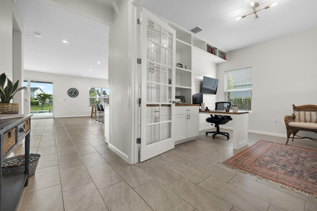 office space with an inviting chandelier