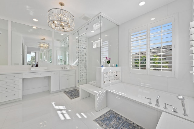 bathroom with tile patterned flooring, vanity, independent shower and bath, and an inviting chandelier