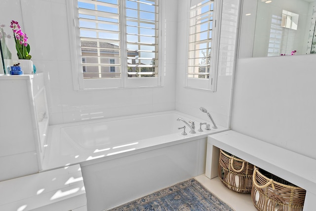 bathroom with a tub to relax in