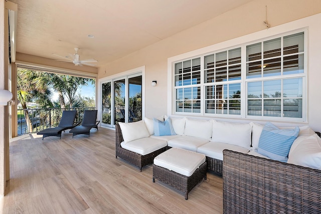 wooden terrace with outdoor lounge area and ceiling fan