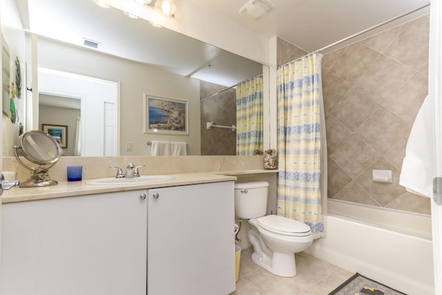 full bathroom featuring toilet, shower / bath combination with curtain, vanity, and tile patterned floors