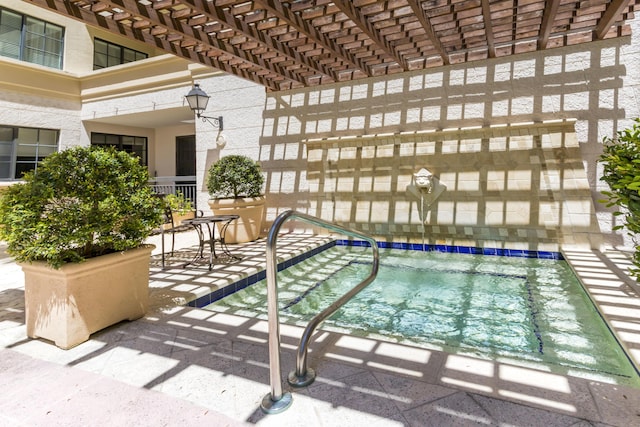 view of swimming pool with a pergola