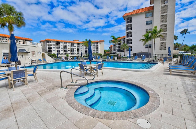 view of pool featuring a community hot tub and a patio area