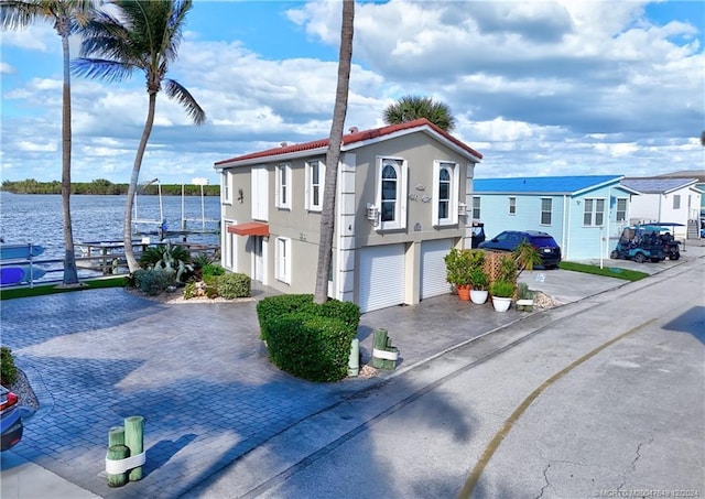 view of front of house featuring a water view and a garage