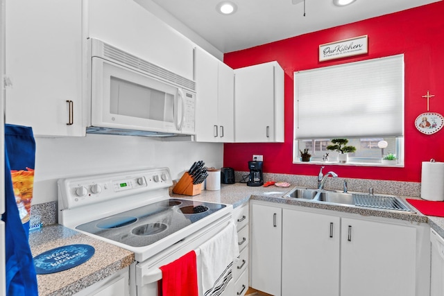 kitchen featuring sink, white cabinets, and white appliances