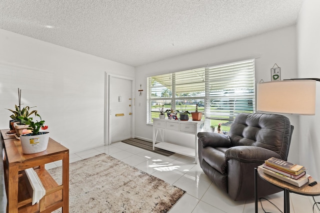 interior space with light tile patterned floors and a textured ceiling