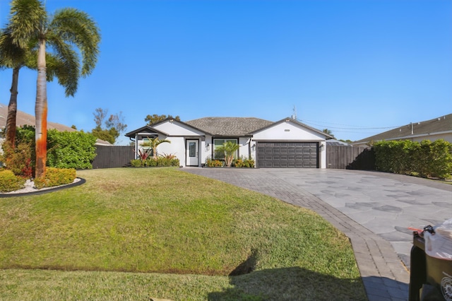 single story home featuring a front yard and a garage