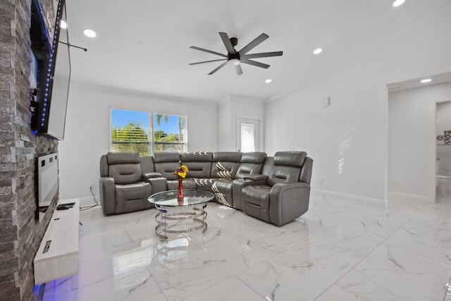 living area featuring ornamental molding, marble finish floor, a fireplace, and baseboards