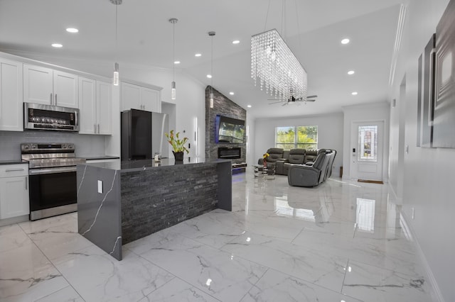 kitchen with appliances with stainless steel finishes, marble finish floor, white cabinetry, and ceiling fan