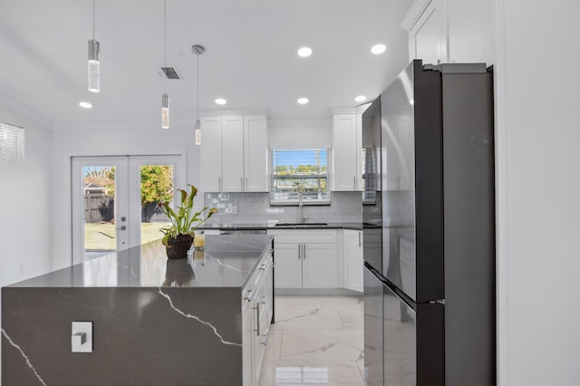 kitchen with recessed lighting, a sink, marble finish floor, freestanding refrigerator, and tasteful backsplash