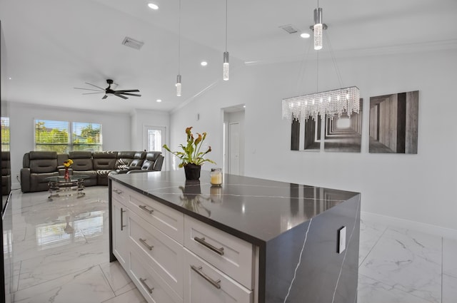 kitchen with white cabinetry, baseboards, marble finish floor, dark countertops, and crown molding