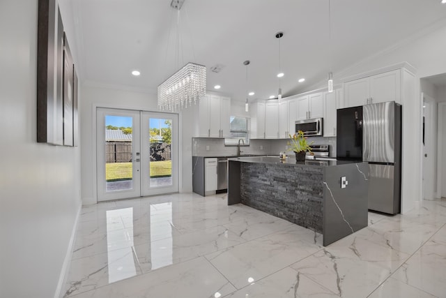 kitchen featuring dark countertops, marble finish floor, stainless steel appliances, french doors, and a sink