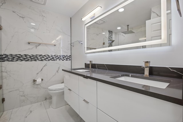 bathroom with marble finish floor, a marble finish shower, and a sink