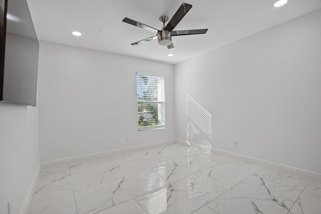 unfurnished room featuring marble finish floor, recessed lighting, and baseboards